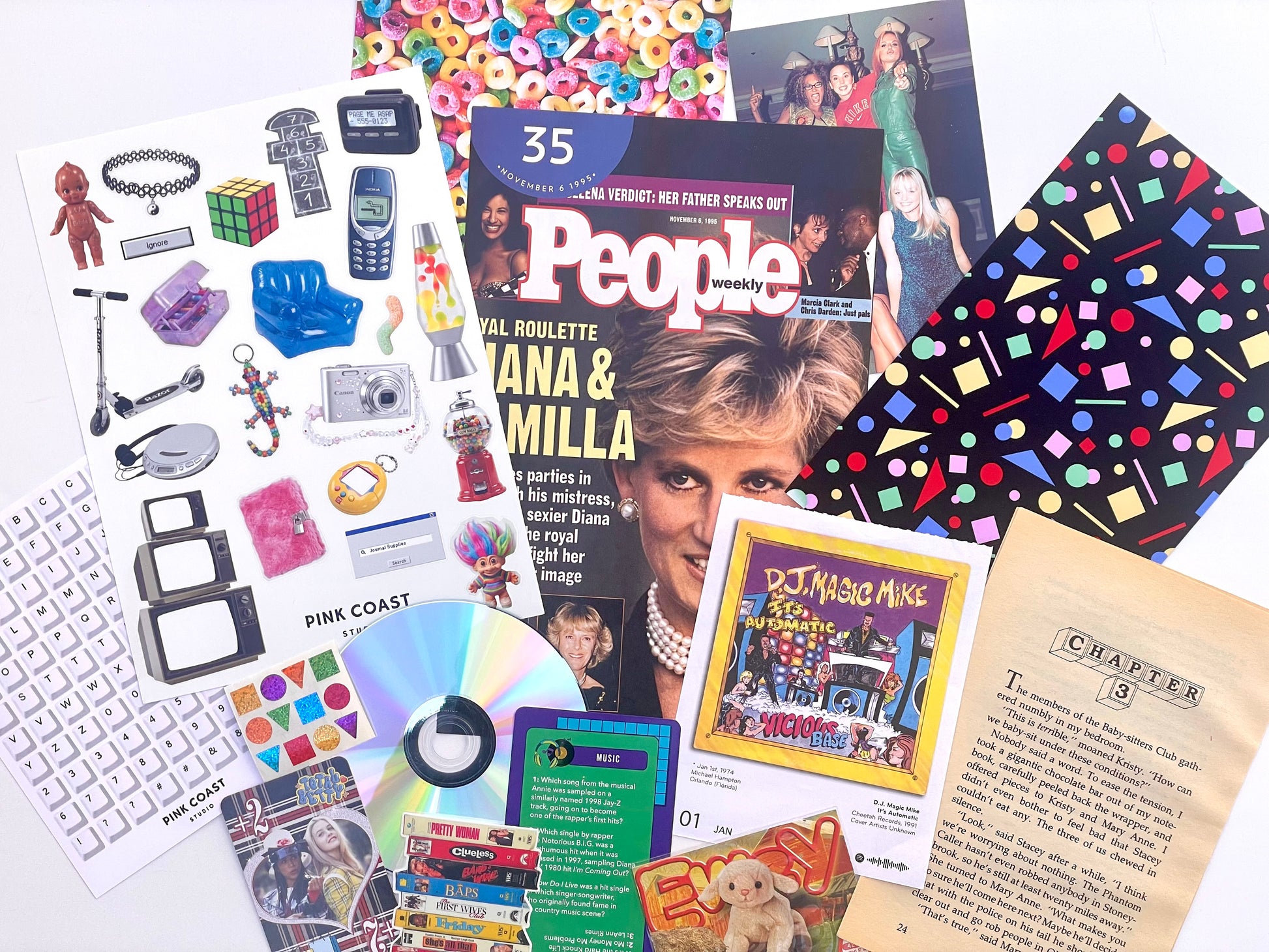 A styled flat-lay collage of various pop culture items, including a People magazine featuring Diana and Michael Jackson, a sheet of keyboard stickers, a CD, a vintage-style book page, and colorful patterned accessories on a white background.
