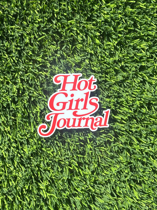 Sticker with 'Hot Girls Journal' text on artificial grass background